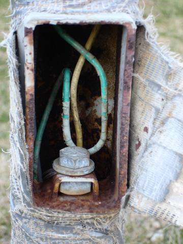 outdoor box open, rusted, conductors exposed