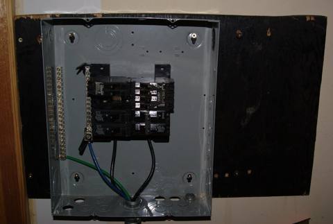 panel with no dead-front cover, breakers and conductors exposed