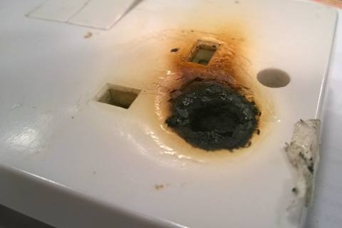 socket outlet scorched and melted around a pin hole
