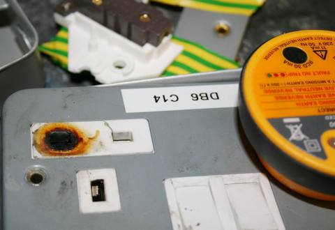 socket outlet scorched around a pin hole