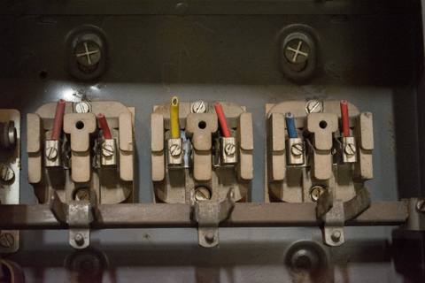 fuse carriers open, live terminals exposed