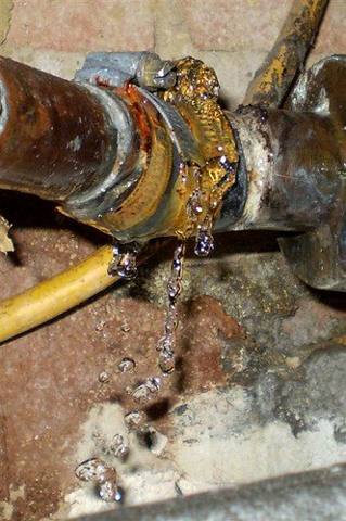 water spraying from a corroded pipe joint