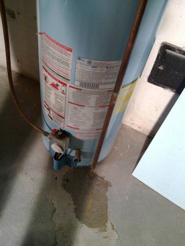 water pooled at the base of a water heater