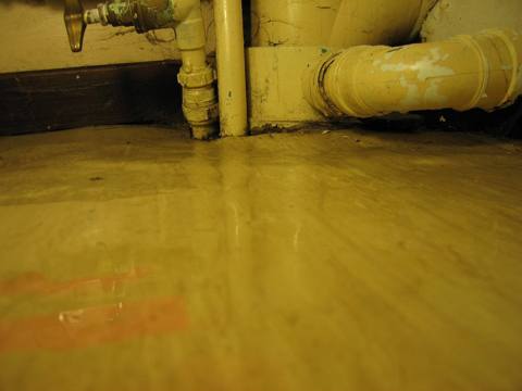flooded floor around pipes