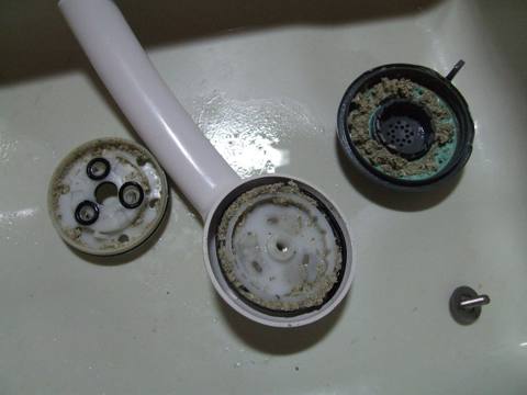 scale on shower head parts, dry