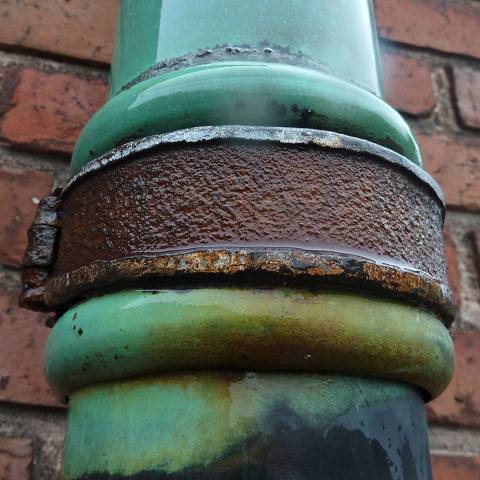 rust on a cast iron pipe collar, dry
