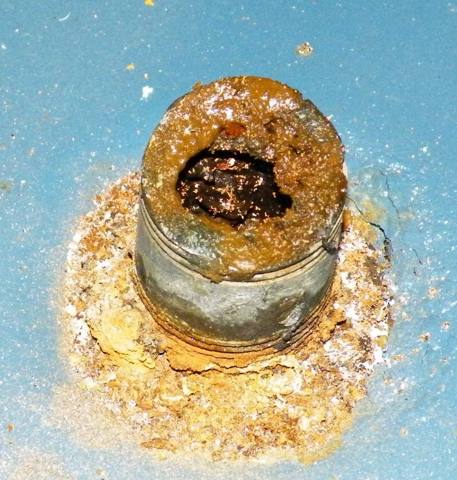 crusted corrosion on a tank fitting, dry