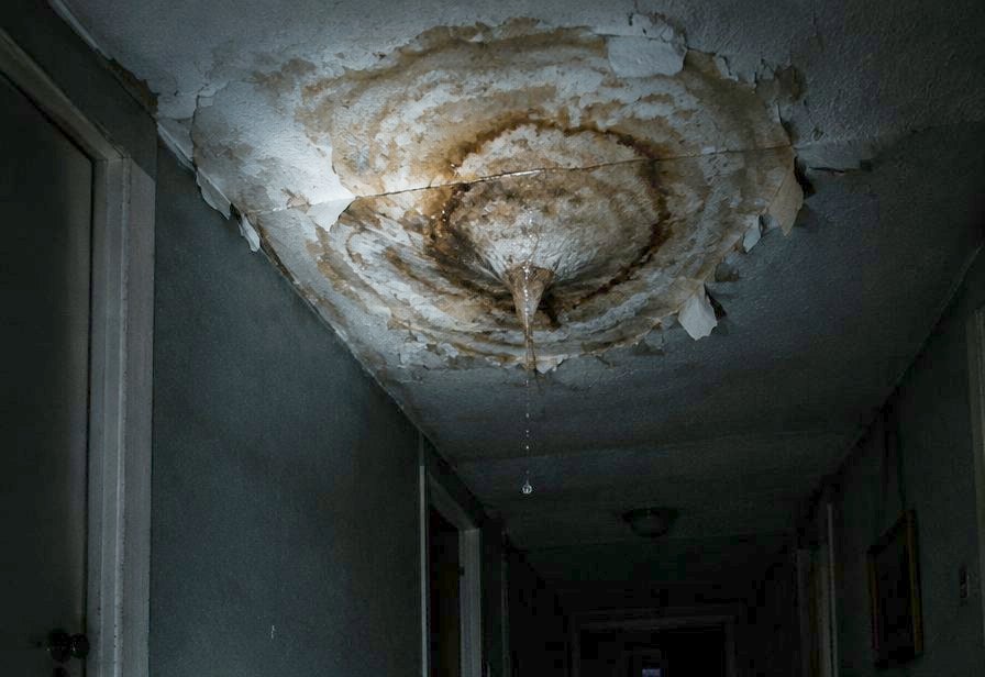 Water coming through a stained, sagging ceiling