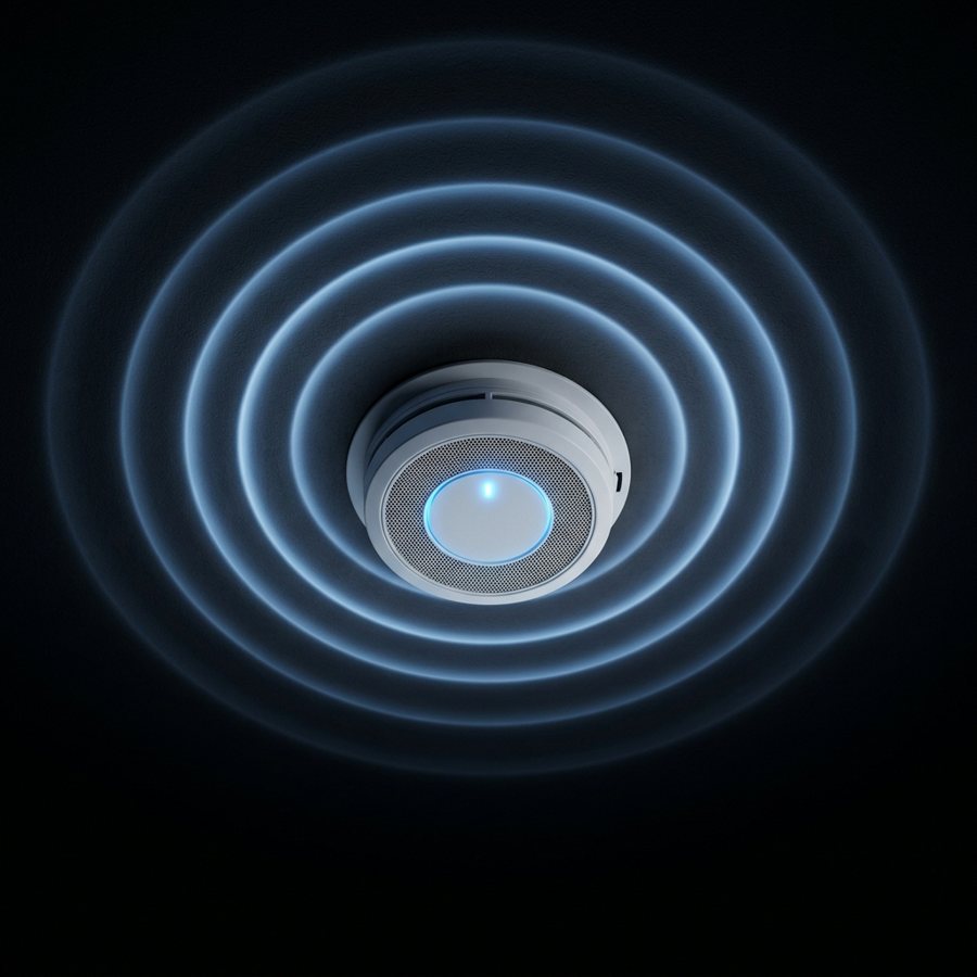 A ceiling smoke alarm with blue rings around it