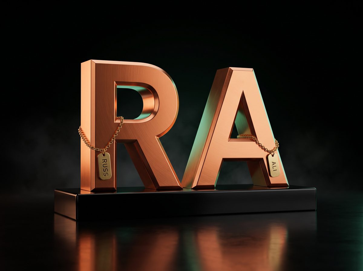 Two copper letters, R and A, on a black stand. A brass tag on the R reads RUSS; a tag on the A reads ALI.
